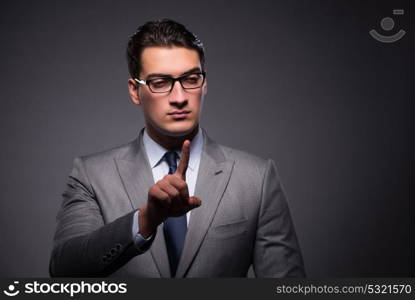 Handsome businessman pressing virtual buttons