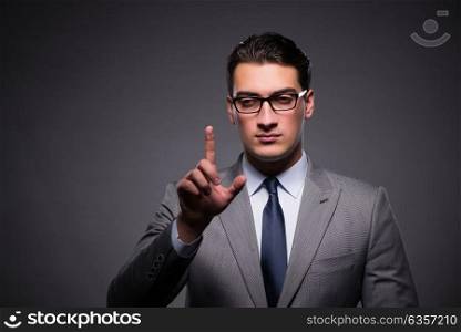 Handsome businessman pressing virtual buttons
