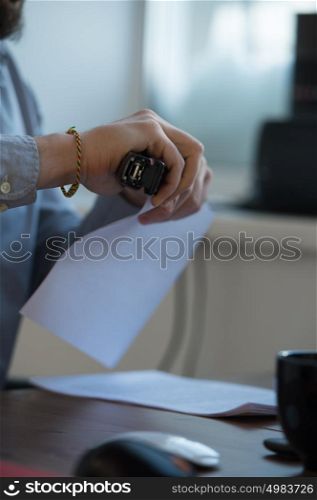 Handsome businessman signing contract in office
