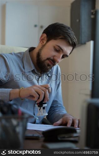 Handsome businessman signing contract in office