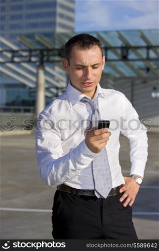 handsome businessman standing in a front of a building site