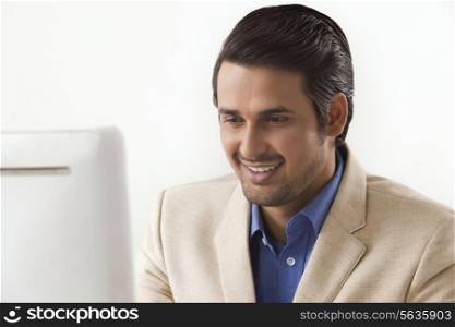 Handsome businessman using computer in office