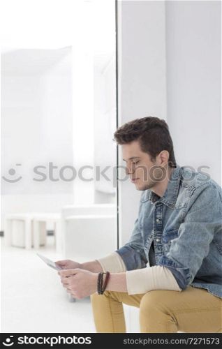 Handsome businessman using digital tablet in office