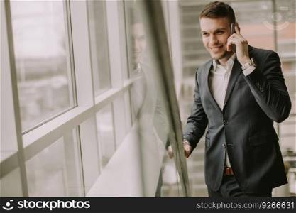 Handsome businessman using smartphone in the office