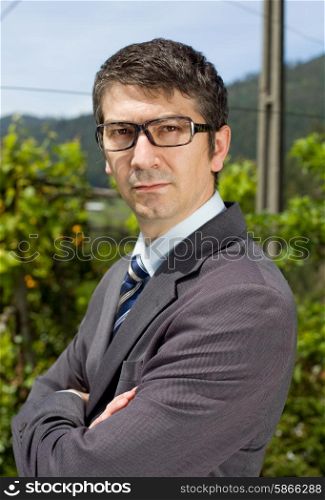 handsome businessman with glasses outdoors