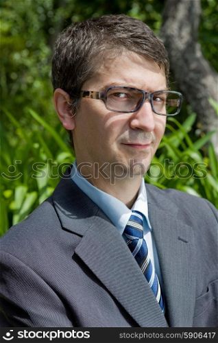 handsome businessman with glasses outdoors