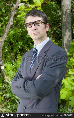 handsome businessman with glasses outdoors