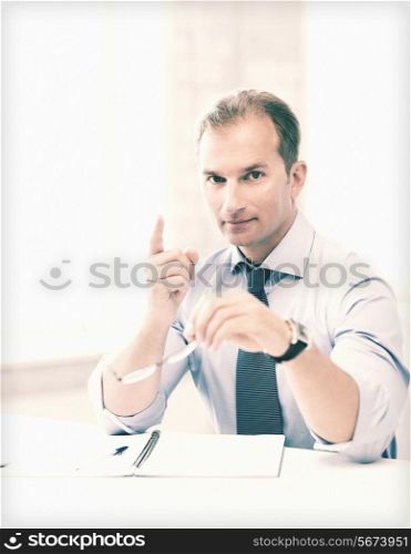 handsome businessman with spectacles showing warning gesture