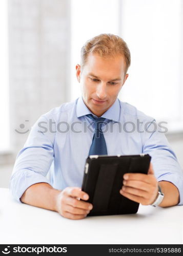 handsome businessman with tablet pc in office