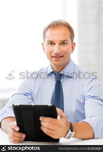 handsome businessman with tablet pc in office