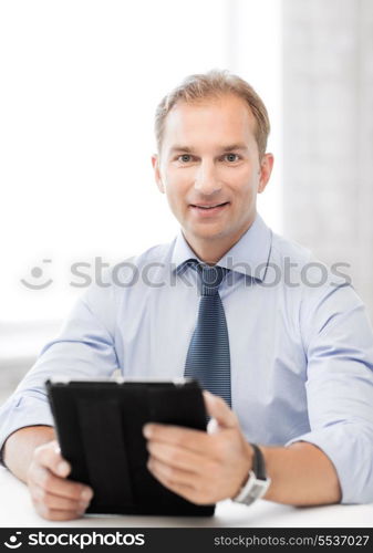 handsome businessman with tablet pc in office