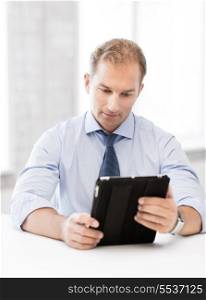 handsome businessman with tablet pc in office