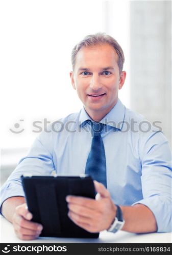 handsome businessman with tablet pc in office. businessman with tablet pc in office