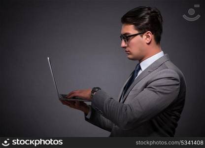 Handsome businessman working on laptop computer