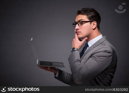 Handsome businessman working on laptop computer