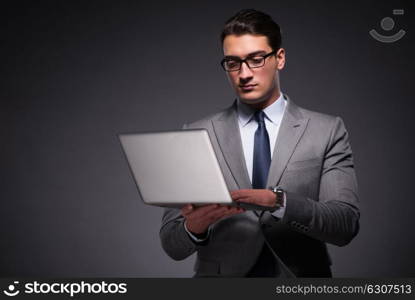 Handsome businessman working on laptop computer