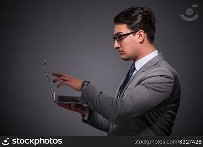 Handsome businessman working on laptop computer