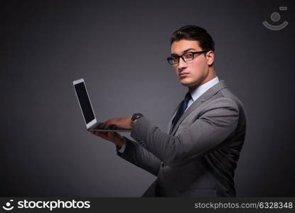 Handsome businessman working on laptop computer