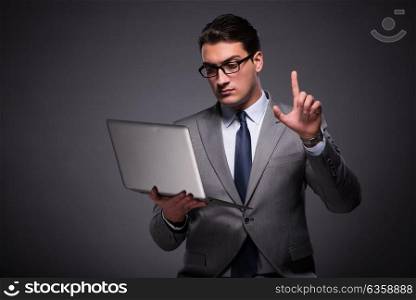 Handsome businessman working on laptop computer