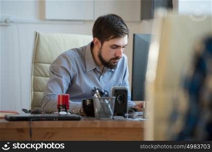 Handsome businessman working with computer in office