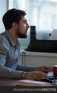 Handsome businessman working with computer in office
