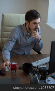 Handsome businessman working with computer in office