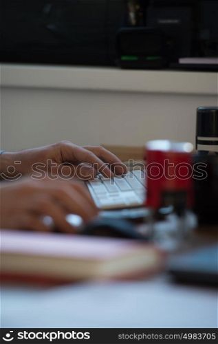 Handsome businessman working with computer in office. Hands closeup