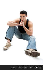 Handsome Caucasian guy wearing black tank top and jeans sitting on floor thinking, isolated