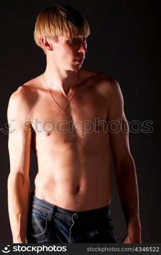 handsome caucasian man is standing on black background
