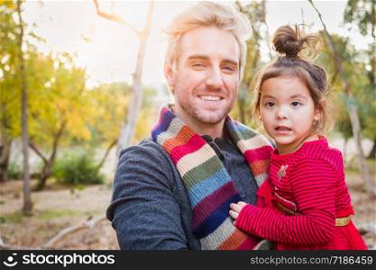 Handsome Caucasian Young Man with Mixed Race Baby Girl Outdoors.