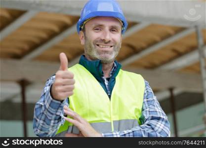 handsome construction worker showing thumb up