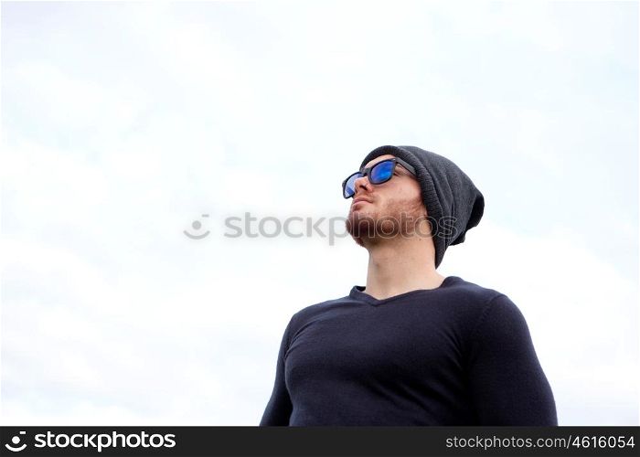 Handsome cool man with cap wool looking away