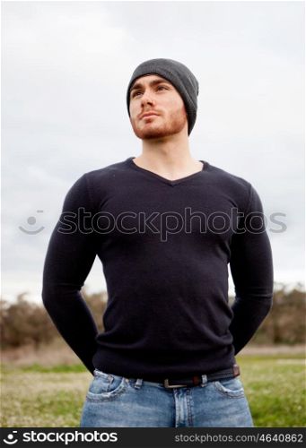 Handsome cool young man with beard and cap wool