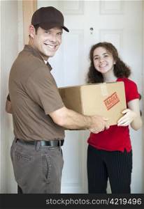 Handsome delivery man smiles as he delivers a package to a customer.