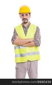 Handsome determined male constructor in hardhat and reflective vest standing with crossed arms on white background and looking at camera. Confident builder looking at camera