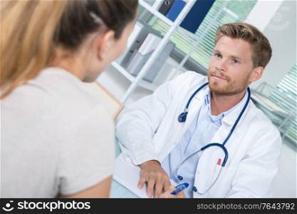 handsome doctor during consultation with female patient