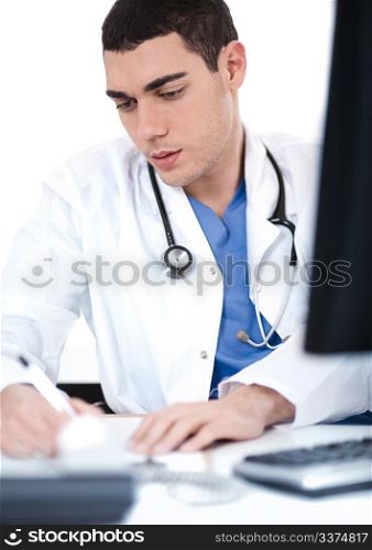 Handsome doctor making notes from the computer at his desk