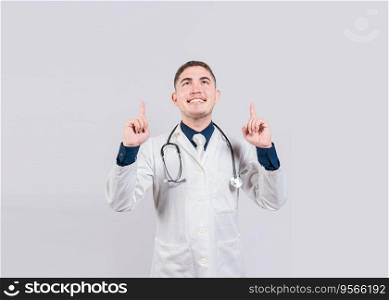 Handsome doctor pointing a advertising up. Happy doctor looking and pointing up isolated. Smiling doctor pointing a promo up