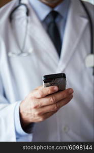 handsome doctor speaking on cellphone at modern hospital indoors