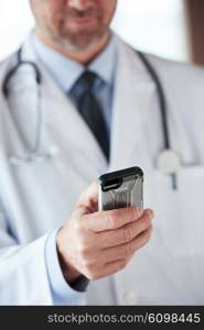 handsome doctor speaking on cellphone at modern hospital indoors