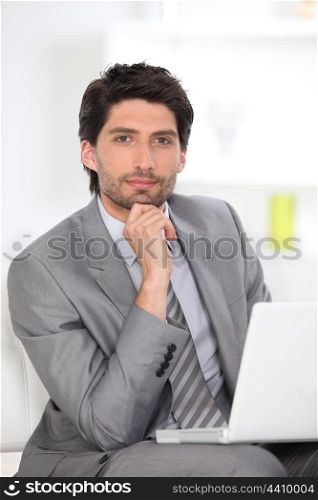 Handsome executive using a laptop computer