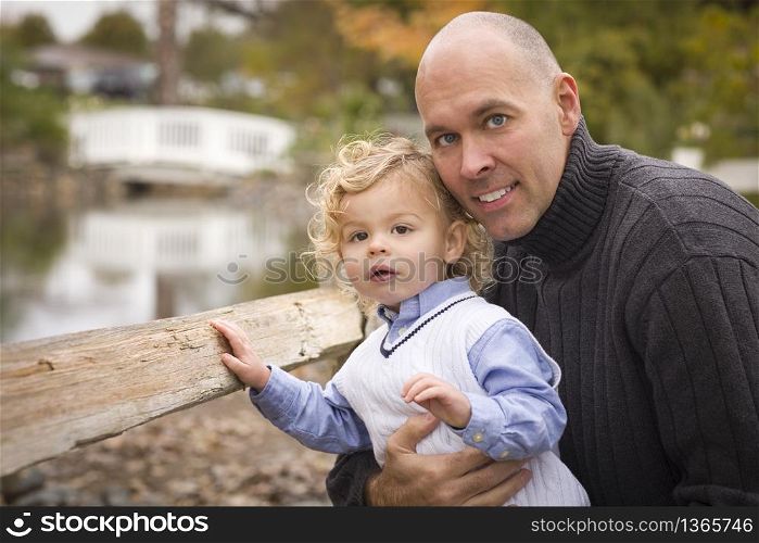 Handsome Father and Son Having Fun in the Park.