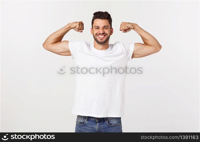 Handsome fit young funny bearded man pointing to his bicep and smiling on white background.. Handsome fit young funny bearded man pointing to his bicep and smiling on white background
