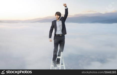 Handsome guy on the ladder above the clouds
