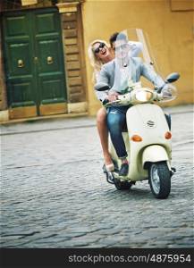 Handsome guy riding a scooter with his girlfriend
