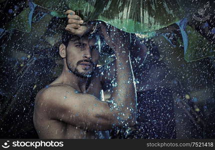 Handsome guy staring at the tropical raing