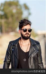 Handsome guy with leather jacket and sunglasses