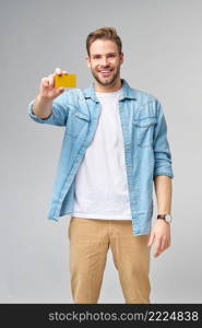 Handsome happy young man showing blank bank cor discount card.. Handsome happy young man showing blank bank cor discount card