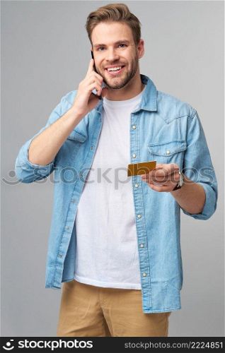 Handsome happy young man showing blank bank cor discount card.. Handsome happy young man showing blank bank cor discount card