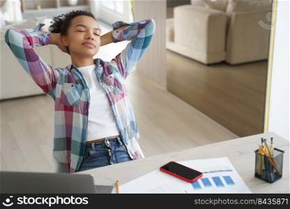 Handsome hispanic girl is studying remote at home. Teenage girl has leaned back, closed her eyes and dreaming. Lazy student distracting at online virtual lesson. Schoolgirl has rest from study.. Lazy student, hispanic girl is studying remote. Teenage girl has leaned back and closed her eyes.